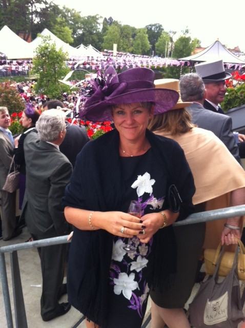 Client wearing a purple wide-brimmed hat with floral trim at Royal Ascot
