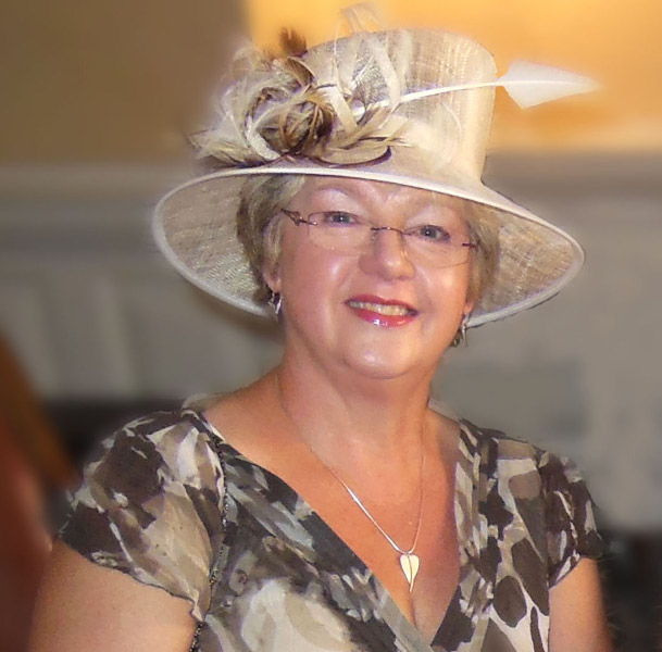 Client wearing an elegant cream wide-brimmed hat with feather trim