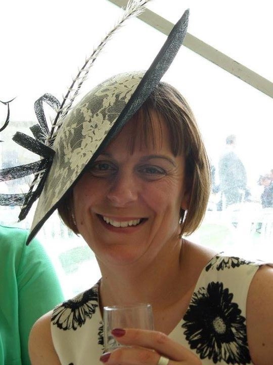 Client wearing an ivory lace fascinator with black sinamay and feather detail from the hire wardrobe